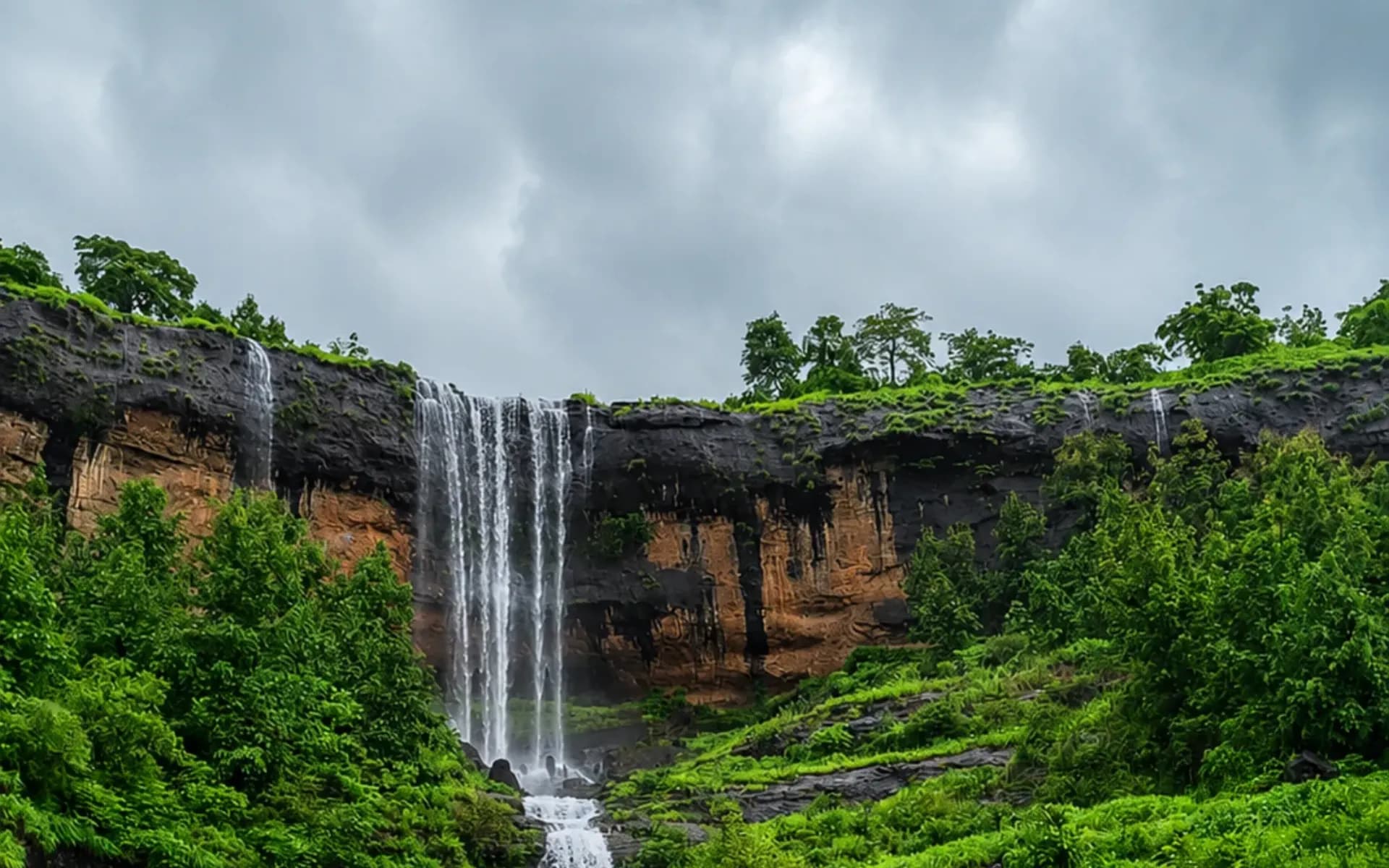 Zenith Waterfall cascading over forested cliffs near Khopoli