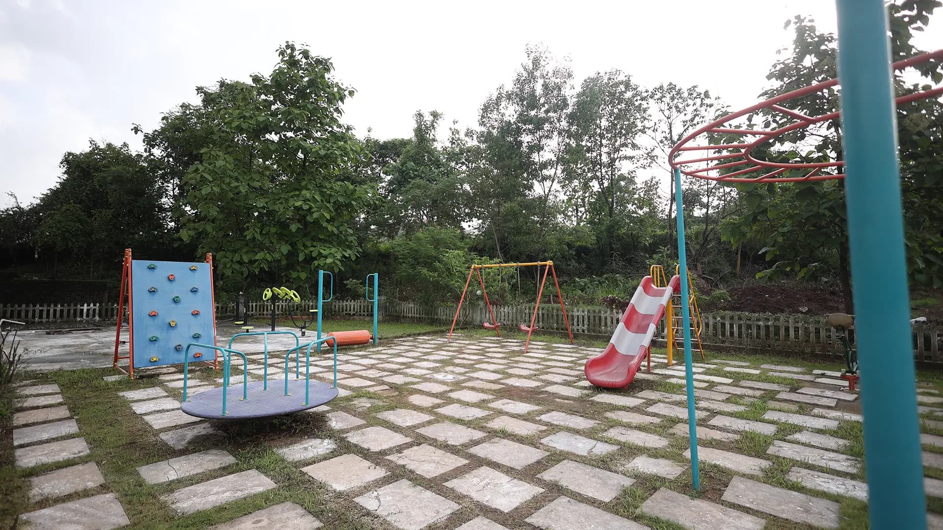 Outdoor kids play area with colourful equipment at the resort