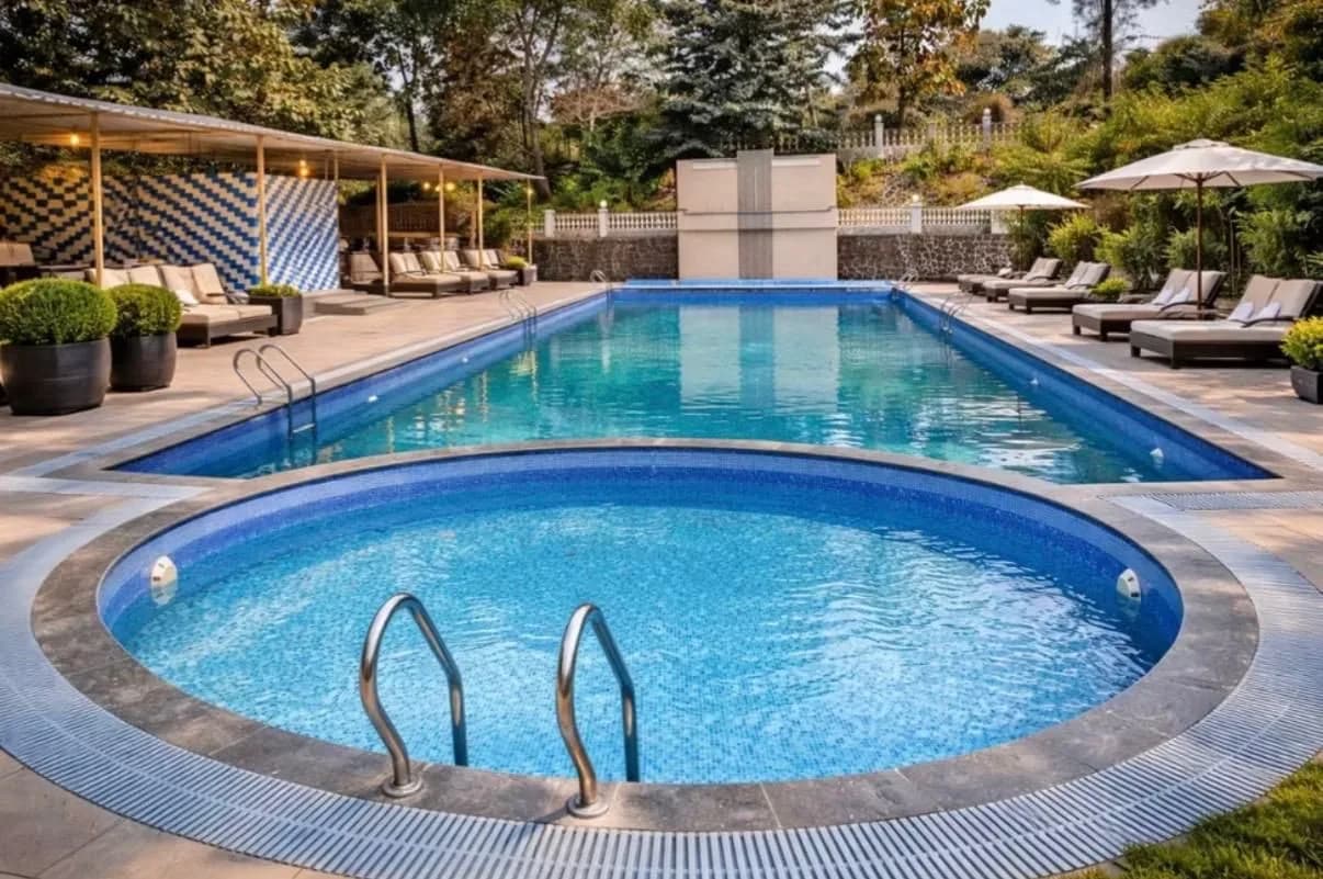 Pool and loungers framed by trees at golden hour